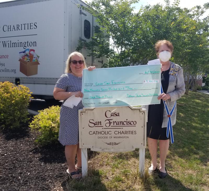 Casa San Francisco representative Andrea Rotsch, left, from Catholic Charities Diocese of Wilmington, accepts a donation check from DAR Delaware State Regent Dr. Gloria Lester. SUBMITTED PHOTO